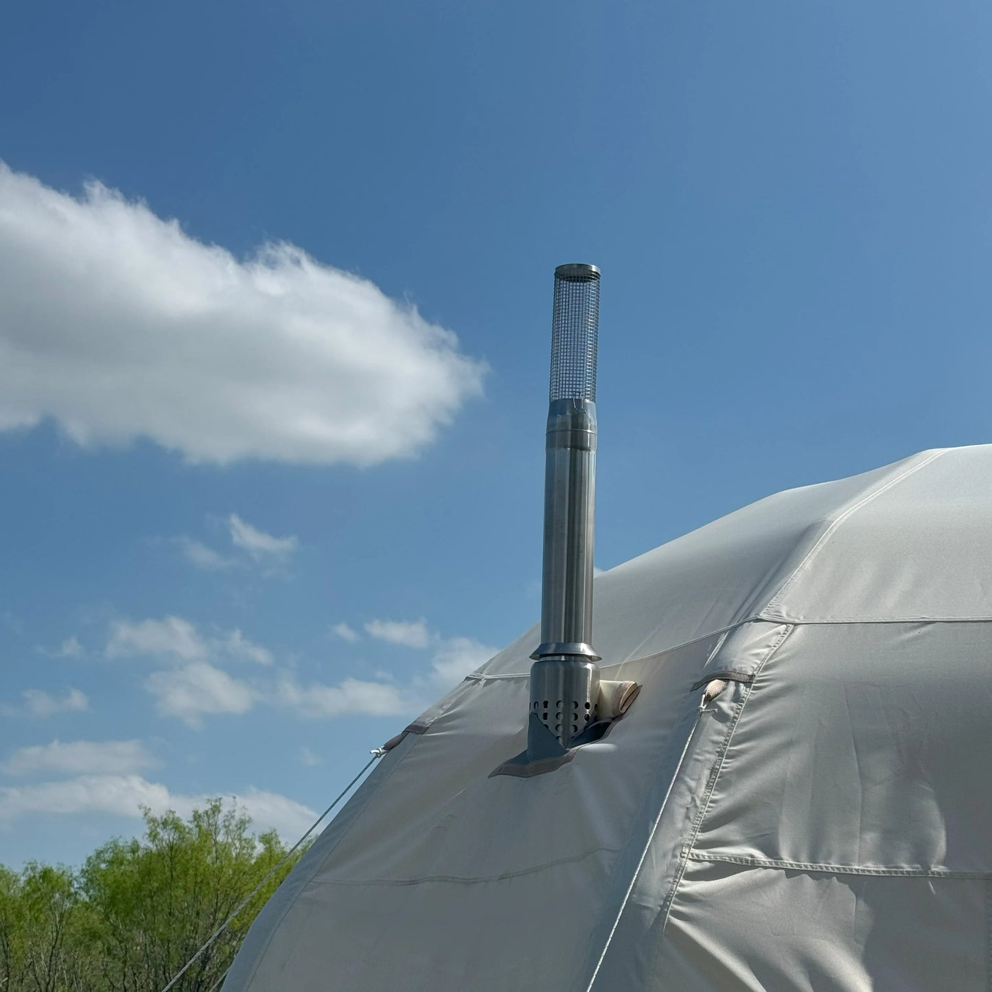 Tent with a chimney against a blue sky