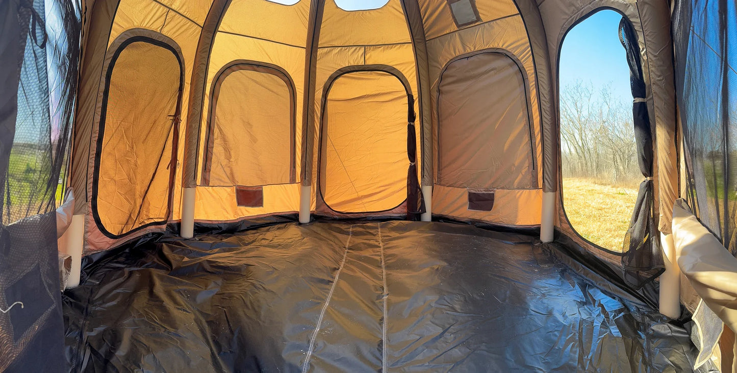 Inside view of a camping tent with a clear view of the outdoors.