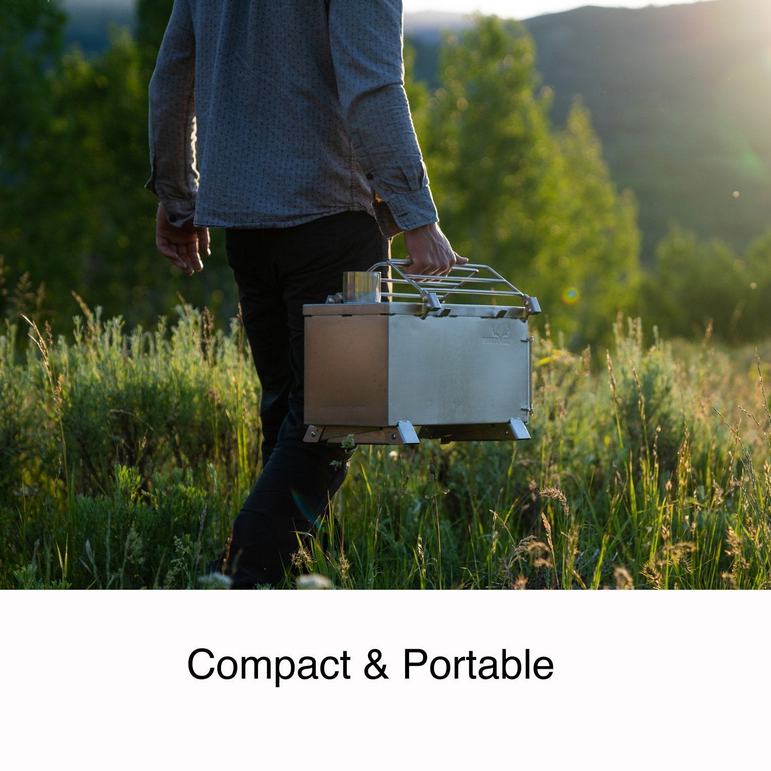 A person demonstrating how easy it is to transport the Nomad Medium stove to their glamping tent