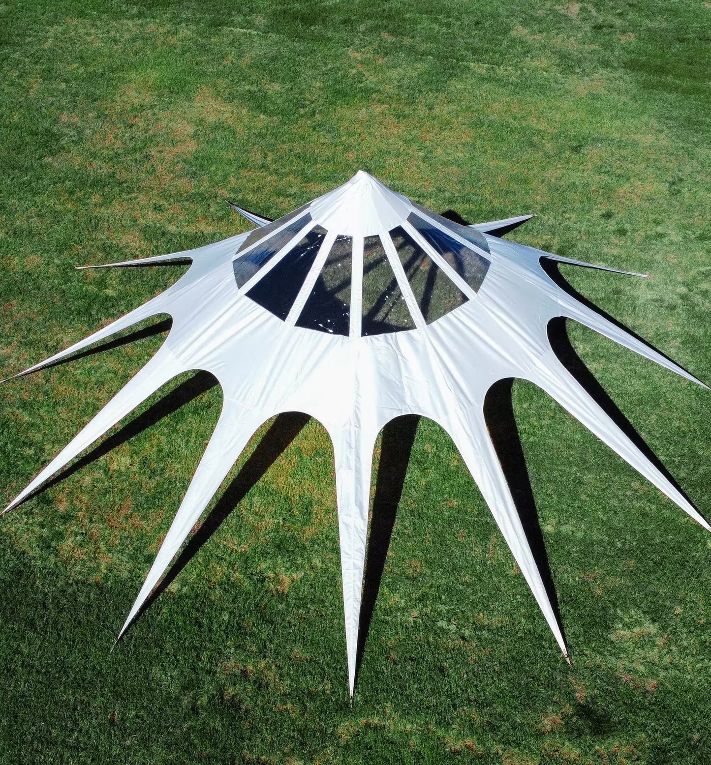 White geometric sculpture on a grassy field