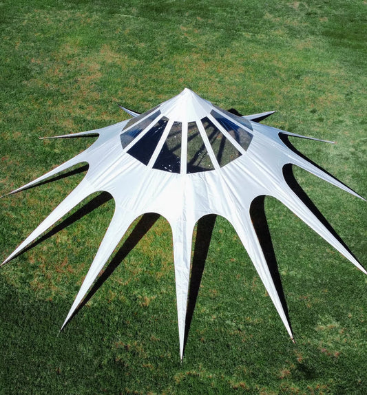 White geometric sculpture on a grassy field