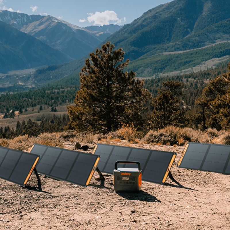 Solar panels and generator set up in a mountainous landscape