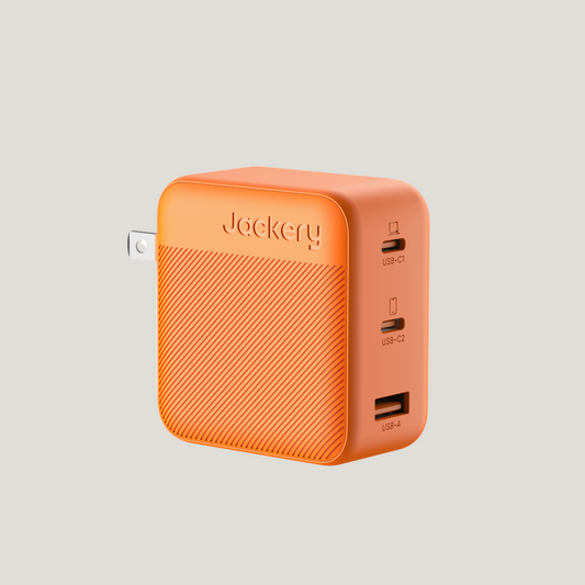 Orange power adapter with multiple USB ports on a white background