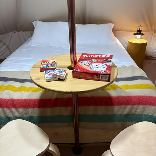 A glamping tent pole table displayed in a Stargazer tent