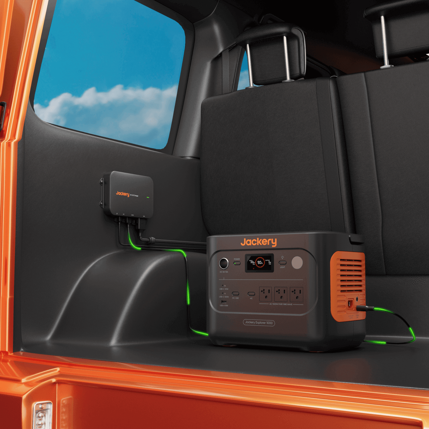 Jackery power station inside an orange vehicle with a clear sky outside
