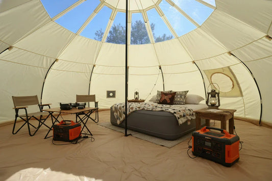 Portable power station charging devices inside glamping tent