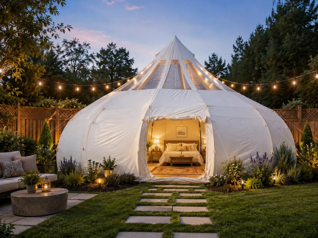 A glamping tent set up as a furnished guest house in a landscaped residential backyard