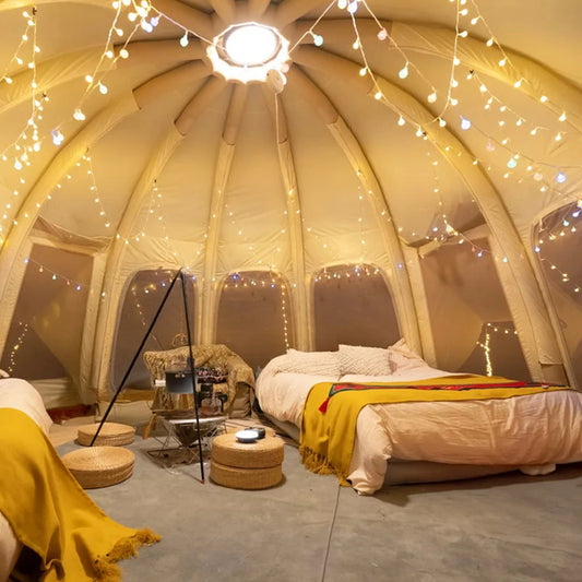 Jellyfish inflatable glamping tent with open interior and no center pole set up at scenic campsite