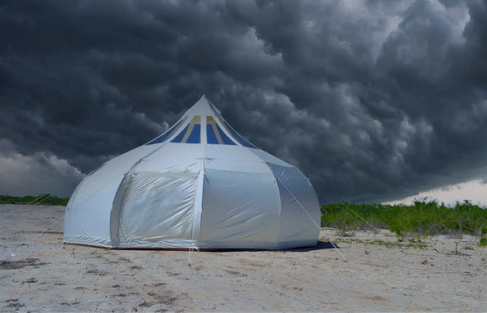 Glamping tent withstanding stormy weather with tensioned guy lines and rain on the fabric
