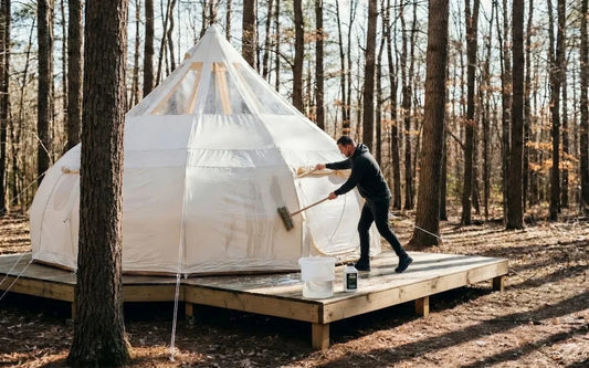 Cleaning glamping tent exterior with soft brush and mild soap to maintain 900D Oxford Canvas fabric