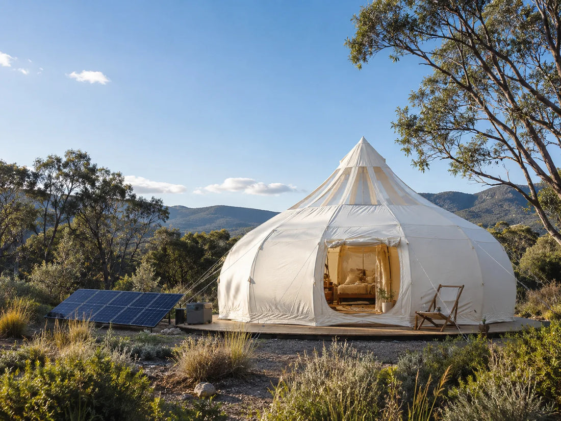 Eco-friendly glamping tent set up with minimal impact on natural surroundings with a solar panel nearby