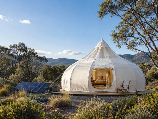 Eco-friendly glamping tent set up with minimal impact on natural surroundings with a solar panel nearby