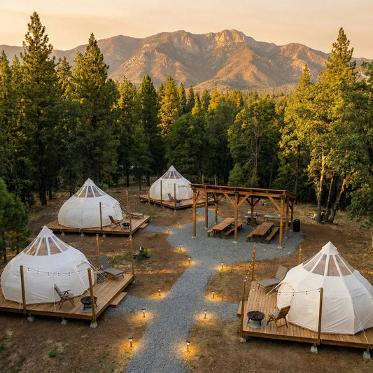 Professional glamping site layout showing multiple tents with platforms, pathways, communal areas, and proper spacing in natural forest setting