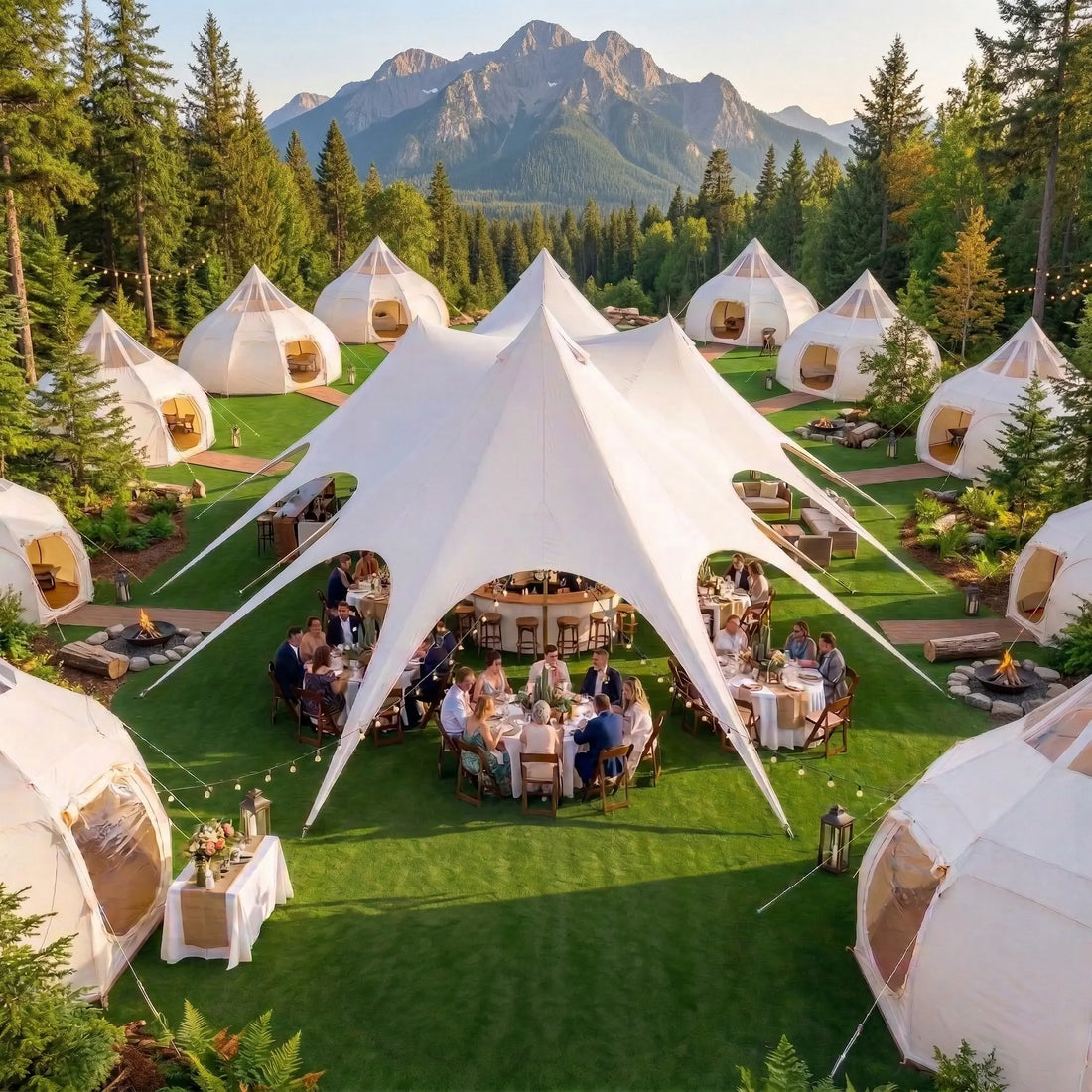 Star Cluster canopy set up for outdoor glamping wedding reception with string lights and dining tables