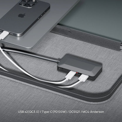 USB hub connected to a smartphone and tablet on a gray surface