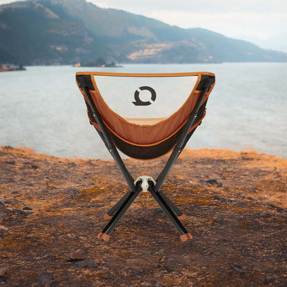 Orange CLIQ ClassiQ portable chair in a natural setting