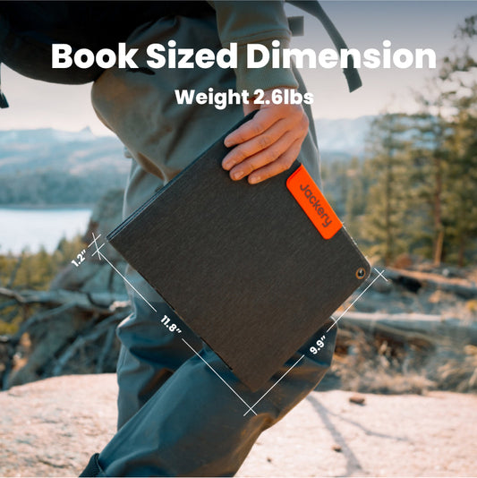 Person holding a book-sized device with scenic background