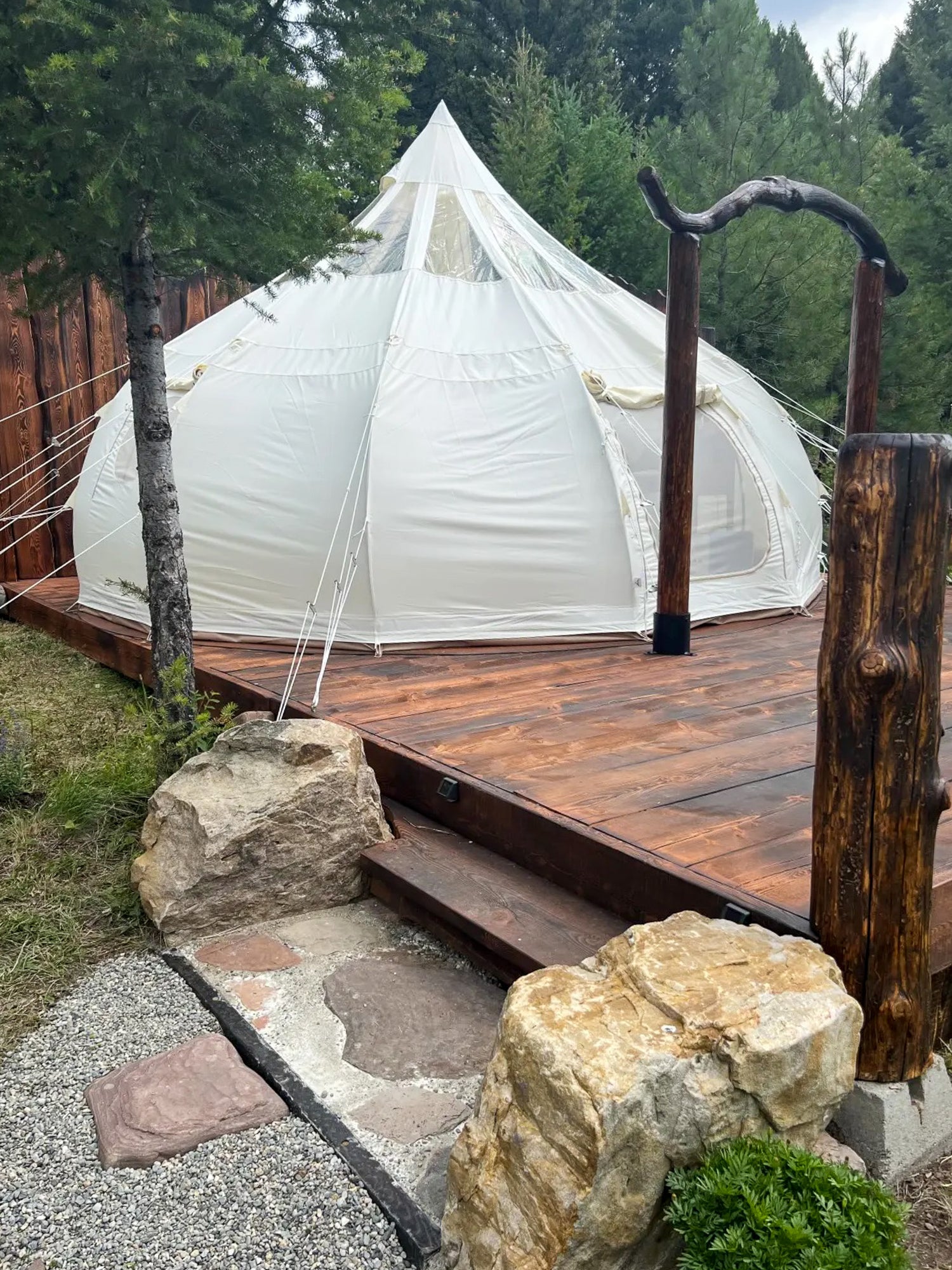 Spectacular glamping tent perched on a scenic cliff edge, harmonizing breathtaking views with unmatched indoor luxuries.